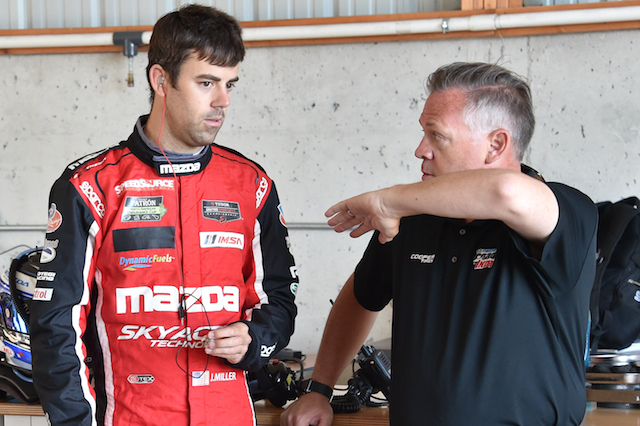 USF-17 project manager Scot Elkins and test pilot Joel Miller use the universal language of driver and engineer during a break in testing at Road America (Photo courtesy of Indianapolis Motor Speedway, LLC Photography)